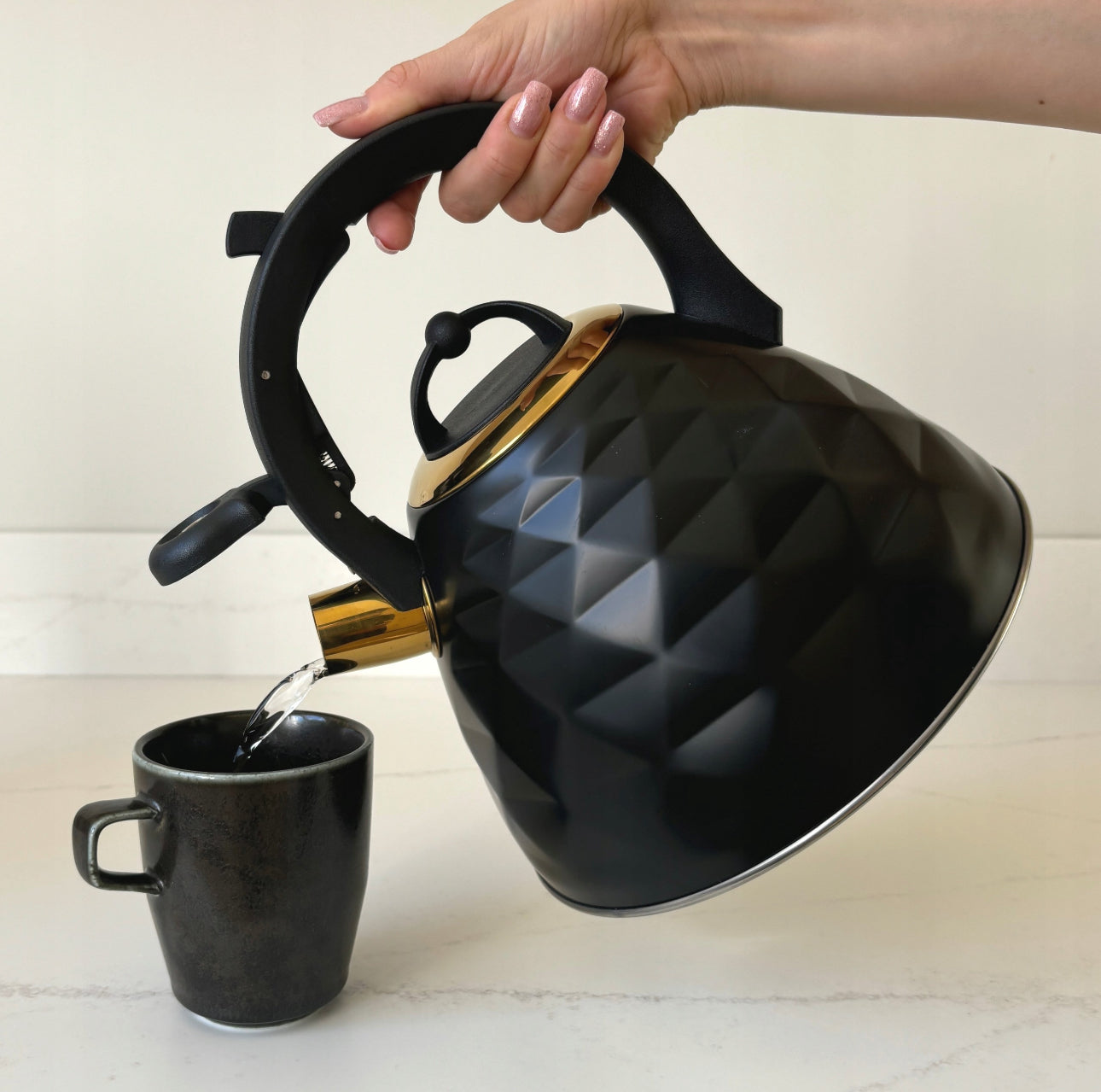 Tradisjonell kjele i rustfritt stål på 3 liter, elegant sort og gull finish, kompatibel med induksjon og gasskoketopper, slitesterk og ergonomisk design.