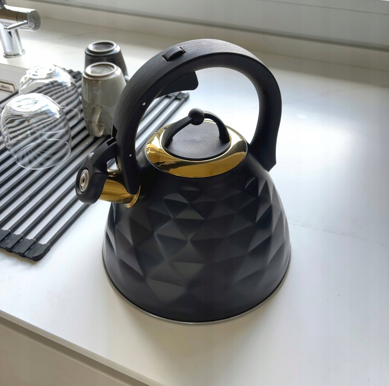 Tradisjonell kjele i rustfritt stål på 3 liter, elegant sort og gull finish, kompatibel med induksjon og gasskoketopper, slitesterk og ergonomisk design.